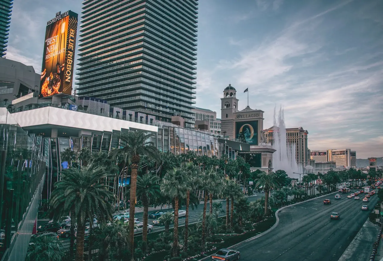 Casino hotels lining a palm-lined boulevard at twilight