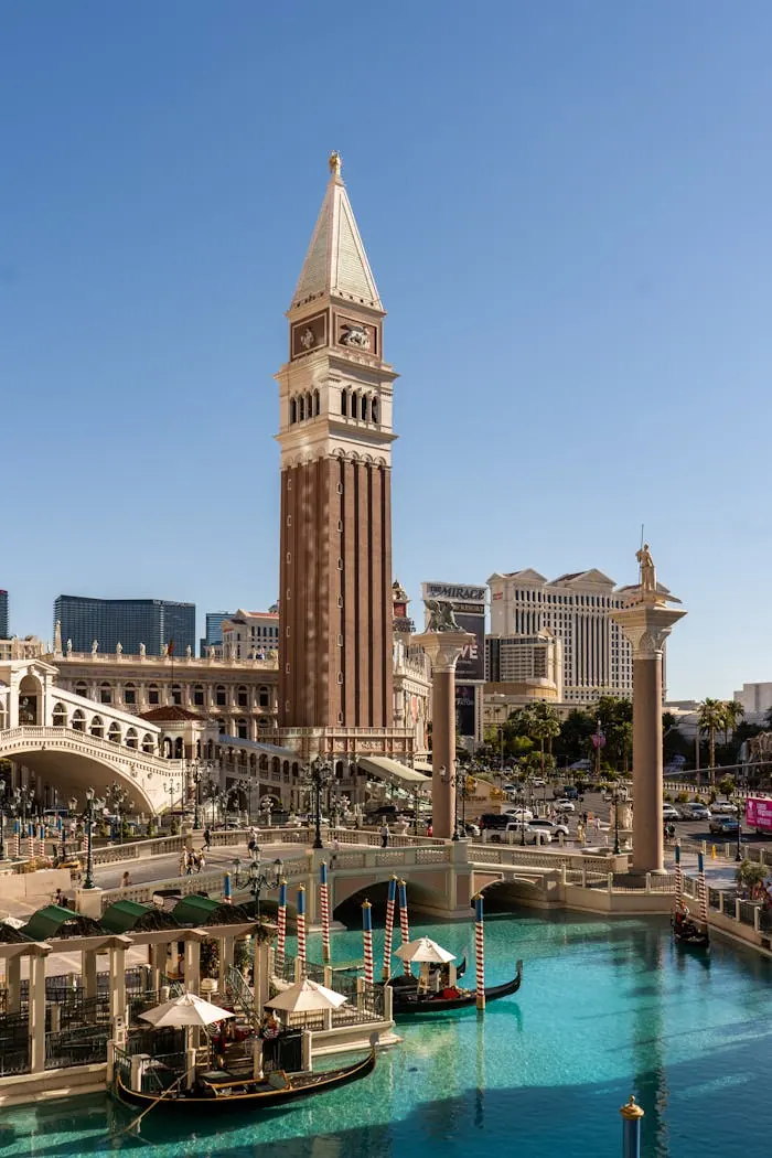 Bell tower and canal beside a casino resort at dusk